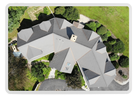 Ariel image of a large home, with a complex roof that was just replaced professionally.