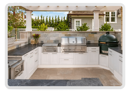 Luxurious pergola-covered outdoor kitchen with granite countertops, commercial-grade appliances, a pizza oven and additional burners.