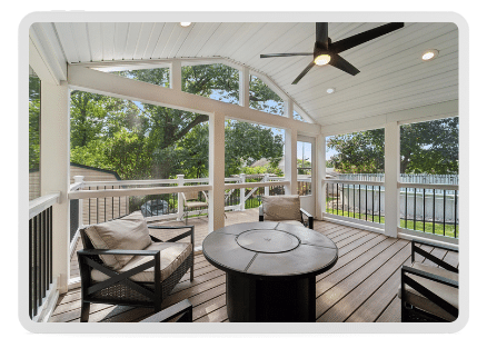 Inviting screened porch with stylish patio furniture and a ceiling fan, designed for enjoying summer days free from insects.