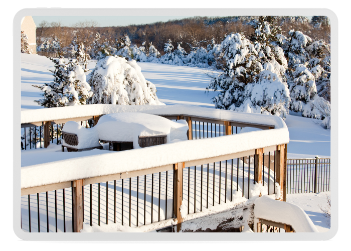 A snow covered deck in the middle of winter after a weekend storm.